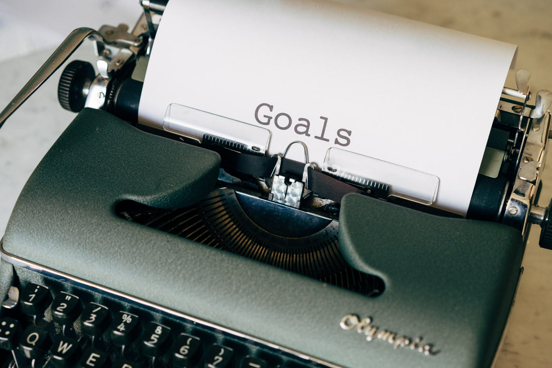 Typewriter with a piece of paper with the world ‘GOALS’ on it