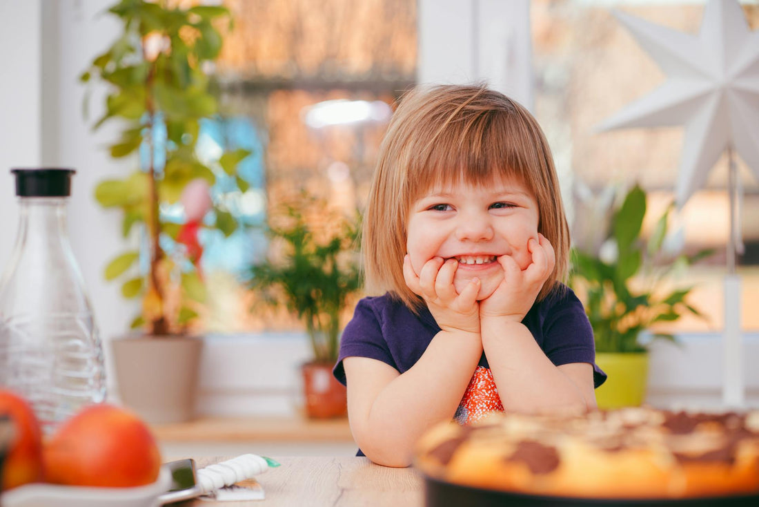 girl smiling at kitchen table
