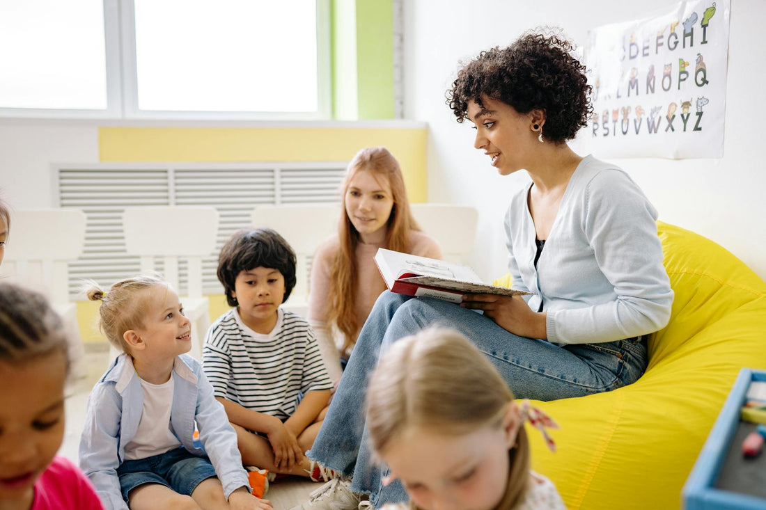 teacher reading a book in a classroom