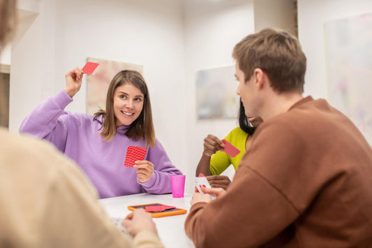 teens playing a card game together